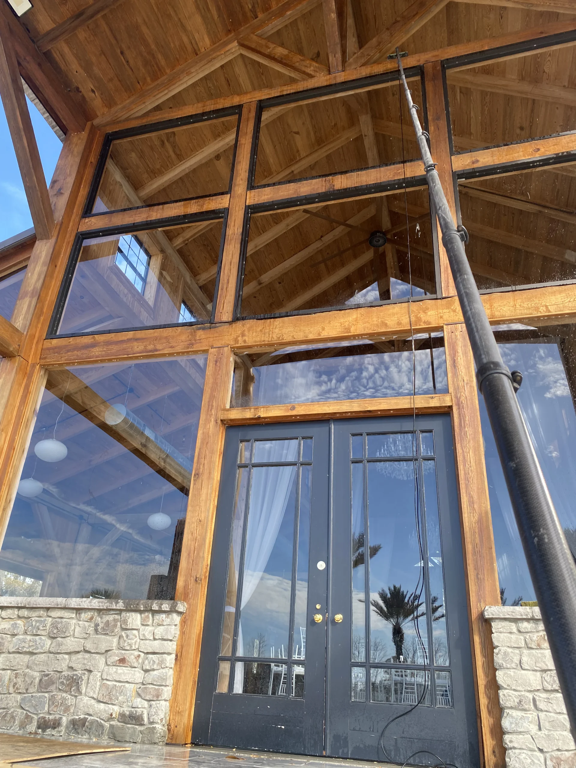 Tall residential windows prepared for professional cleaning in Jacksonville Beach, FL