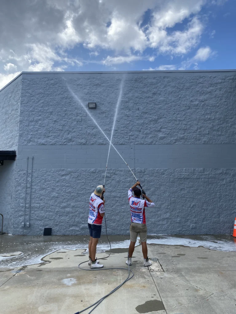 Pressure washing in Jacksonville, FL cleaning a commercial building exterior wall