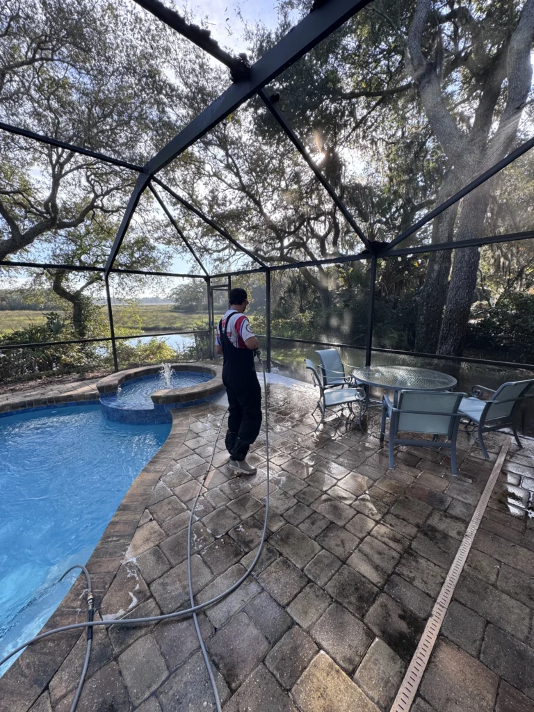 Technician performing soft wash house cleaning on a residential property in Jacksonville Beach FL